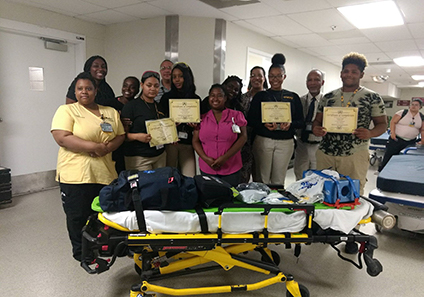A group of people holding certificates. Some have gone through the Emerging Leaders program.